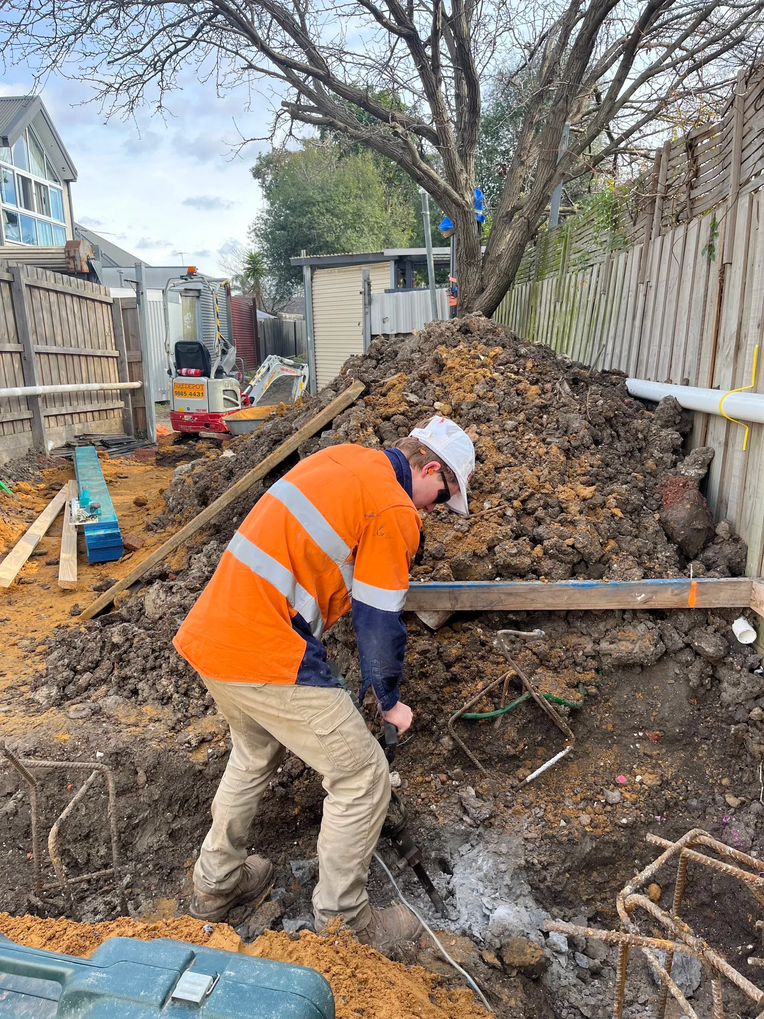 Leg-Up Labouring workers on residential excavation site performing site preparation work