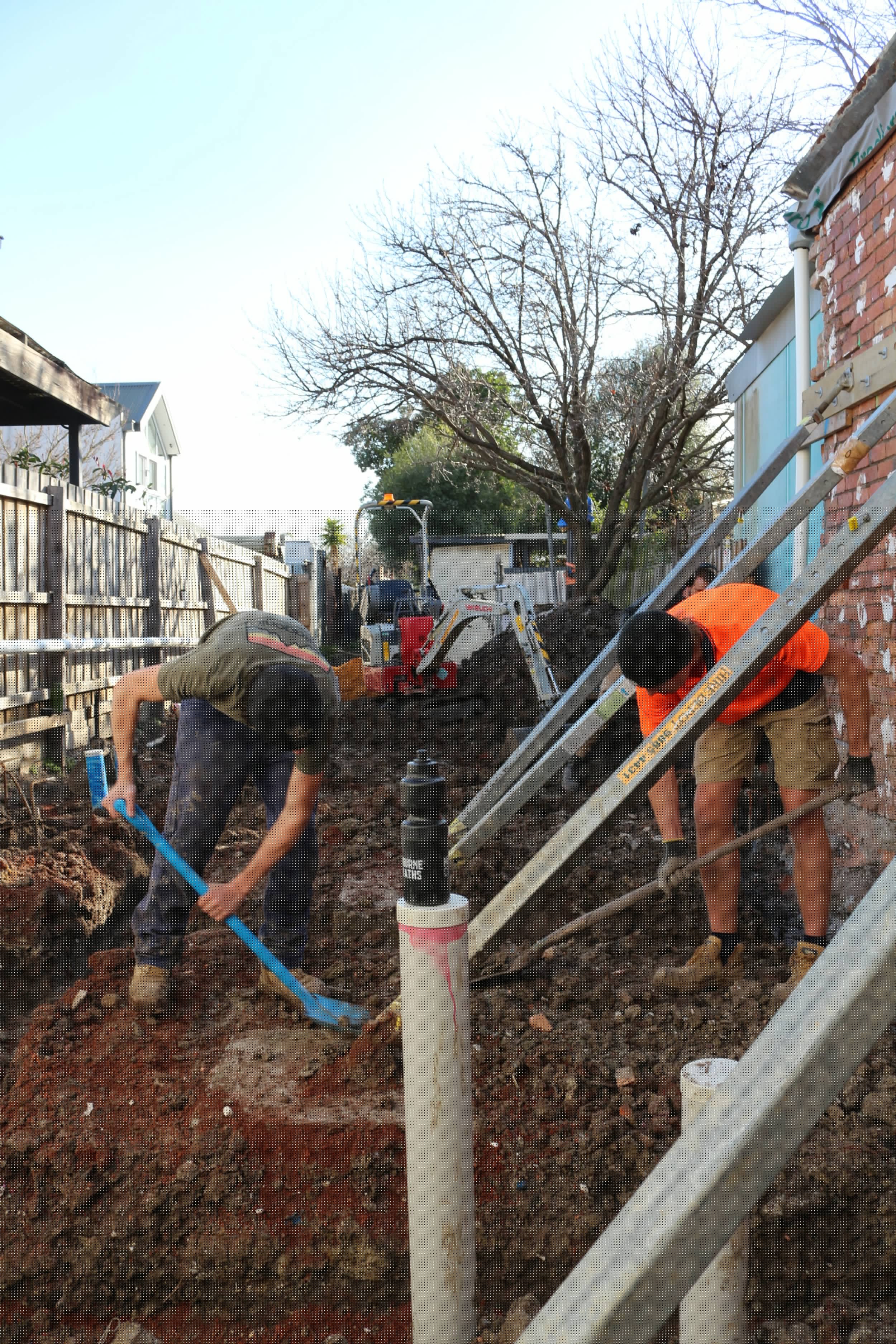 Leg-Up Labouring worker performing interior construction work on commercial building site